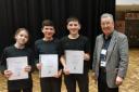 From L to R: Eli, Elliot and Jack with Stephen Gray, a former headteacher who adjudicated at the branch final.