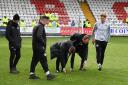 Match officials inspect the pitch before postponing Stevenage's home game with Barnsley. Picture: TGS PHOTO