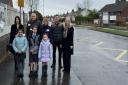 Teachers, governors and pupils are petitioning for a zebra crossing and 20mph zone outside their school in Hitchin.