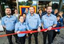 Manager Kyle Fitzgerald (centre) cut the ribbon to officially reopen the store.