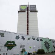 The Grenfell Memorial Wall sits beneath the tower.