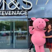 Percy Pig and happy customer, Elaine Hawkes outside the new Stevenage M&S store