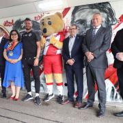 From L to R: Lucy Webster, captain of Stevenage FC Women; Mike Pink; Cllr Myla Arceno, mayor of Stevenage; Ronnie Henry, Stevenage FC record appearance holder; Boro Bear; Cllr Richard Henry; Cllr Phil Bibby; Adrian Hawkins OBE.