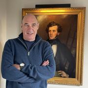Bill Lindsay with a portrait of his ancestor William Schaw Lindsay