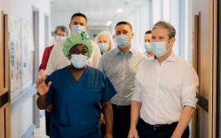 Sir Keir Starmer being shown around Stevenage's Lister Hospital by a member of staff.