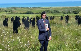 Alex Clarkson proudly shows off a picture of his grandfather, who fought on D-Day back in 1944.