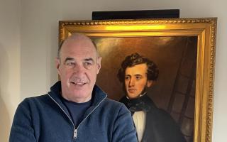 Bill Lindsay with a portrait of his ancestor William Schaw Lindsay