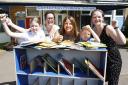 Pupils and staff at Carterton Primary School celebrate their new books following a £1,700 donation