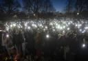 People in the crowd turn on their phone torches as they gather in Clapham Common, London, after the Reclaim These Streets vigil for Sarah Everard was cancelled