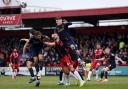 Dan Sweeney battles in the air against two Bradford City defenders