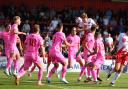 Carl Piergianni heads home surrounded by a sea of pink Barnsley shirts. Picture: TGS PHOTO