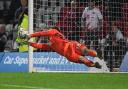 Murphy Cooper saves the final Guiseley penalty to send Stevenage through in FA Cup. Picture: TGS PHOTO