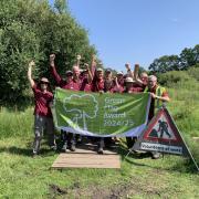 Volunteers at Oughtonhead Common celebrate their Green Flag award.
