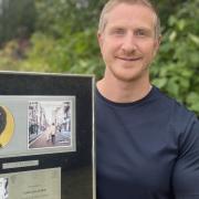 Anthony Lanni proudly shows off the gift given to him by Liam Gallagher back in 1996.