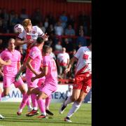 Carl Piergianni heads home surrounded by a sea of pink Barnsley shirts. Picture: TGS PHOTO