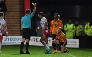 Louis Thompson of Stevenage receives a yellow card - and a suspension. Picture: TGS PHOTO